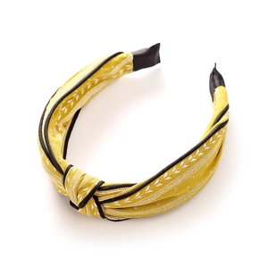 Knotted yellow fabric headband with white leaf embroidery and black edge for women