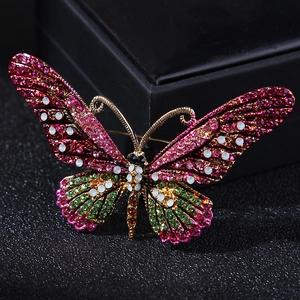 Detailed macro view of vibrant butterfly brooch with colorful rhinestones and gold alloy frame