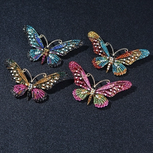 Detail of colorful crystal butterfly brooches with intricate enamel and alloy plating
