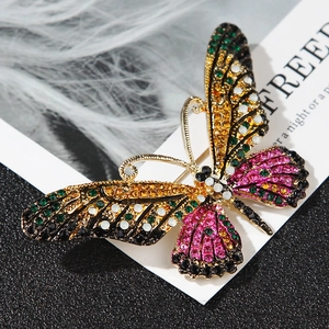 Detailed view of colorful rhinestones on a golden butterfly brooch with fine craftmanship