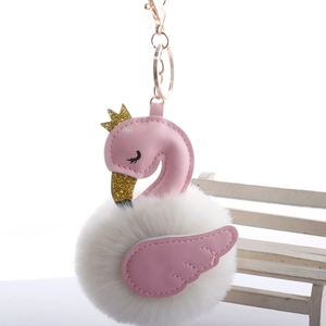 Close-up of pink swan pompom keychain with gold crown and metallic lobster clasp detail