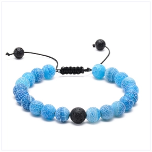 Close-up of sky blue crackle beads and black lava stone on adjustable braided bracelet