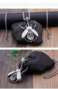Detailed steampunk mechanical beetle pendant with inner gears on a thick rope chain