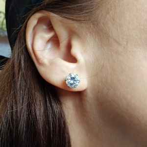 Close-up of a 316 steel ear piercing stud with a six-prong sparkling zircon setting