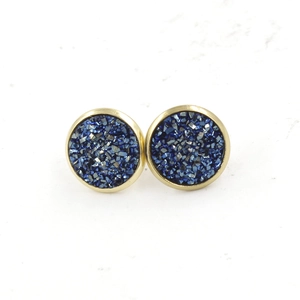 Macro detail of 12mm gold-plated stainless steel studs with sparkling blue druzy resin inlay