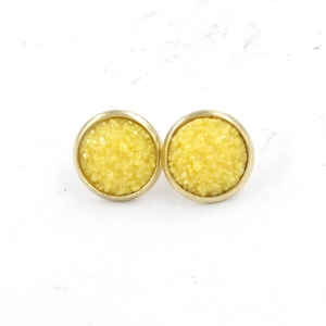Detail of 12mm gold plated stainless steel stud earrings with yellow druzy resin crystals