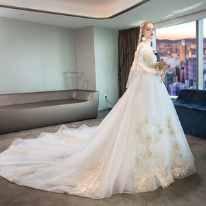 Elegant off-shoulder bridal gown featuring long sleeves and long floral embroidery train