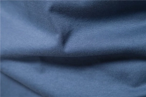Macro view of high-density navy blue knit fabric showing soft texture and drape