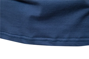 Close-up of the double-needle stitched hem on a navy blue cotton casual t-shirt