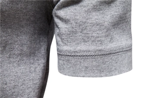 Macro shot of double-needle stitching on grey cotton-blend knit short sleeve T-shirt cuff