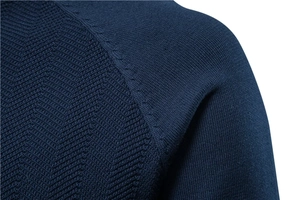 Detail of navy blue men's sweater showing shoulder seams and knit texture patterns