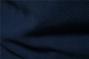 Detailed macro view of dark blue knit fabric showing premium wavy texture and high-density weave