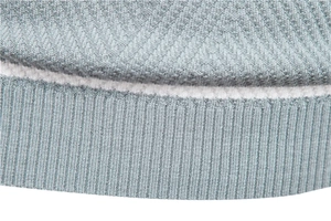 Macro shot of grey-blue knit sweater showing high-density flat knit and ribbed cuff detail