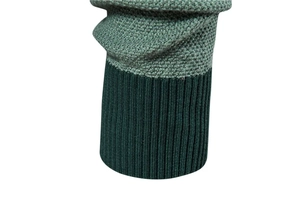 Detail of knitted sweater cuff featuring contrast stitching and ribbed texture