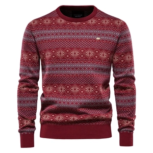 Close-up of Nordic snowflake pattern and fine knit texture on burgundy crewneck sweater