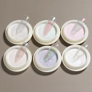 Detail view of solid aurora nail powder jars with iridescent chrome finish on sample tips