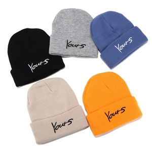 Flat lay of knit beanies in five colors featuring Yours embroidered lettering detail
