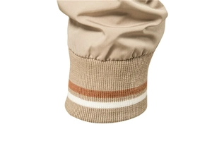 Detailed macro view of khaki jacket ribbed cuffs with orange and white striped accents