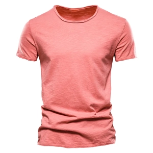Detail of coral pink men's summer t-shirt in breathable slub cotton fabric texture