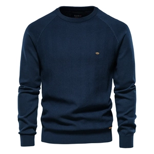Close-up of navy blue men's sweater featuring textured chevron knit and raglan sleeves
