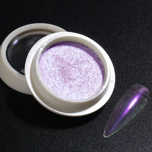 Detail of purple aurora nail powder with pearlescent chrome finish on dark background
