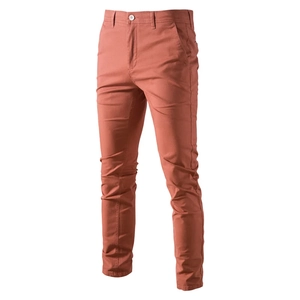 Vertical view of men's slim fit cotton chino trousers in dark rust orange color