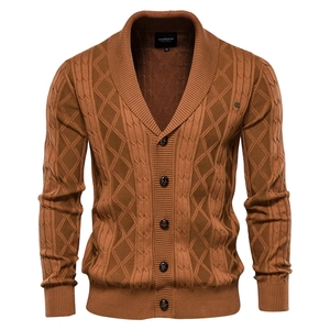 Detailed view of caramel brown knit cardigan featuring cable patterns and shawl collar
