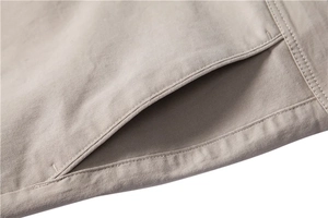 Macro view of side pocket stitching and twill cotton texture on khaki casual trousers
