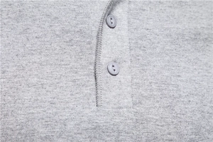 Detailed macro view of the grey Henley neck placket with two matching resin buttons