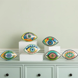 Macro detail of colorful ceramic evil eye ornaments on a minimalist display stand