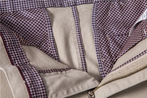 Detailed close-up of khaki cotton chinos featuring a geometric print inner lining