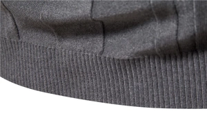 Close-up of dark grey knit texture and ribbed hem on men's turtleneck sweater