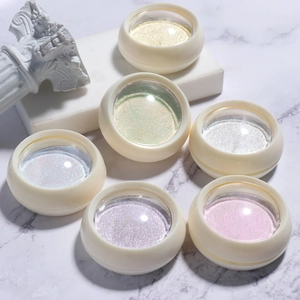 Close-up of solid aurora chrome nail powder set on white marble and plaster decor
