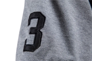 Close-up of black embroidered number three on grey cotton polo shirt short sleeve