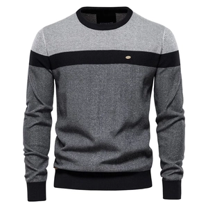 Detail of color block knitted sweater with ribbed crew neck and grey stripe pattern