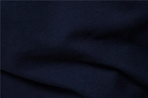 Macro view of breathable navy blue cotton knit fabric texture on a men polo shirt