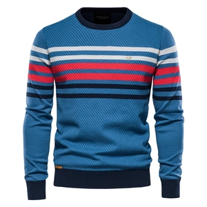 Detailed view of the ribbed round neckline and striped waffle knit texture of this blue sweater