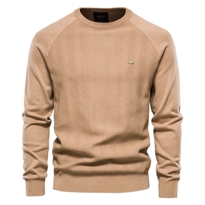 Detailed close-up of camel knit sweater featuring premium herringbone weave texture and crew neck
