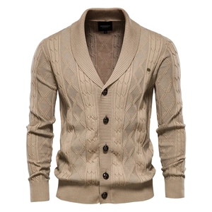 Detailed view of men's shawl collar cardigan featuring knit diamond and cable textures