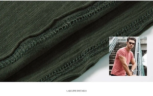 Macro detail of slub cotton fabric and precise car line stitching on olive green t-shirt