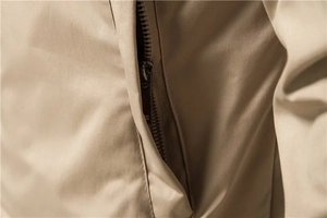 Macro detail of high-quality metallic zipper and khaki woven fabric on men's casual jacket