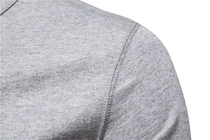 Detailed close-up of double-stitched shoulder seams on a grey cotton henley t-shirt
