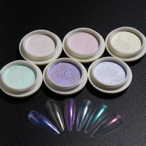 Close-up of 6 aurora nail powder pots with iridescent color shifts on black background