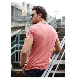 Detailed back view of men's slim fit T-shirt in coral pink slub cotton fabric