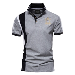 Detail of grey cotton Polo shirt showing side black and white stripes and logo