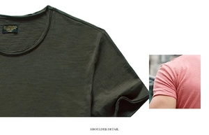 Detail of shoulder stitching and slub cotton texture on dark green slim fit t-shirt
