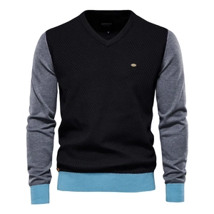 Detail of V-neck collar with tricolor stripe pattern and metallic logo on knit sweater