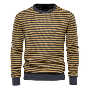 Detail of grey and yellow striped knit sweater showing ribbed cuffs and neckline texture