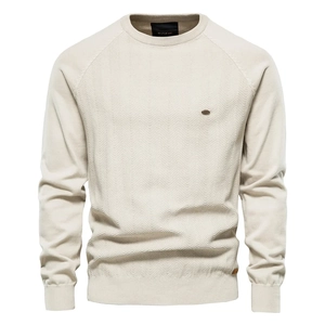 Detail of men's beige crew neck knit sweater featuring herringbone texture and raglan sleeves