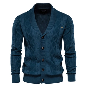 Close-up of navy blue cable knit cardigan featuring a shawl collar and ribbed texture